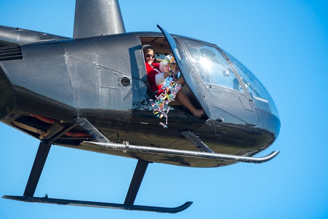 Devin Soeseno, principal at Carencro Catholic dressed as Mrs. Claus and drops toys and candy from helicopter flown by an elf. December 18, 2020.