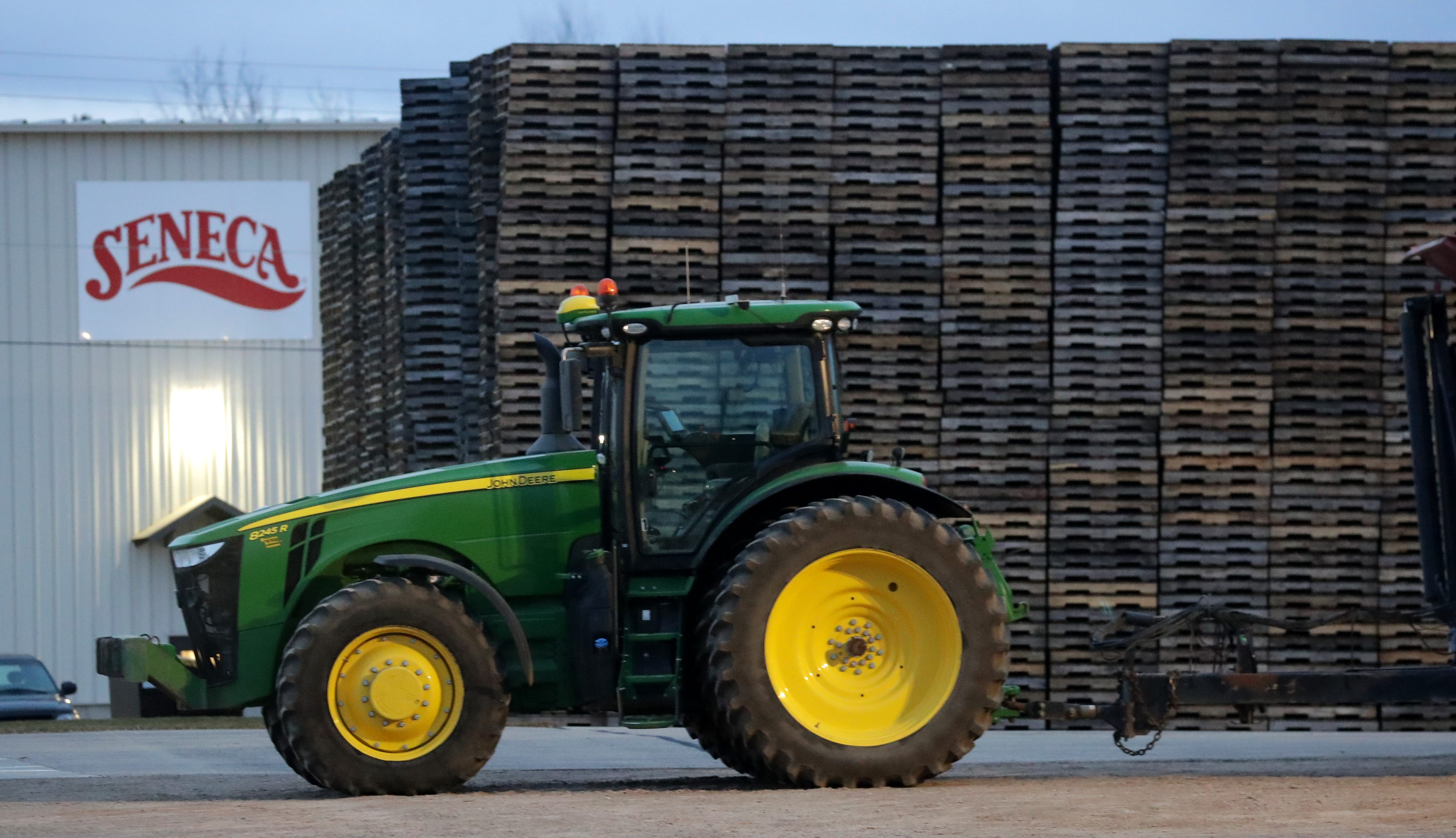 A tractor is parked in front of stacked pallets at the Seneca food plant in Gillett, Wisconsin.