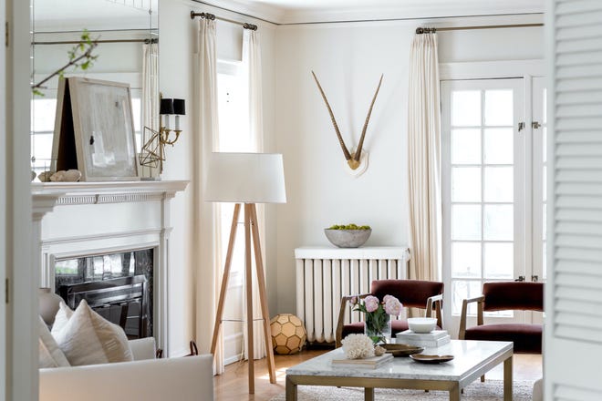 A tripod floor lamp brings functional lighting and maximum visual punch to this living room.