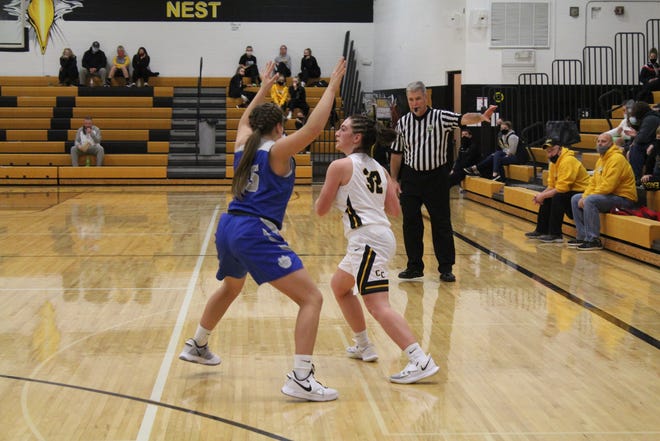 Colonel Crawford's Kaylyn Risner looks to pass around Wynford's Katie Wagner.