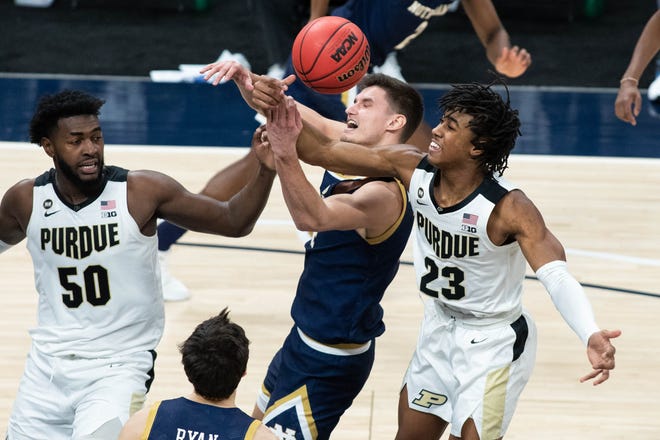 Dec 19, 2020; Indianapolis, Indiana, USA; Notre Dame Fighting Irish forward Nate Laszewski (14) is fouled by Purdue Boilermakers guard Jaden Ivey (23) in the first half at Bankers Life Fieldhouse. Mandatory Credit: Trevor Ruszkowski-USA TODAY Sports