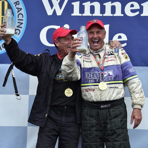 Bob Lazier, right, celebrates after winning a pro-