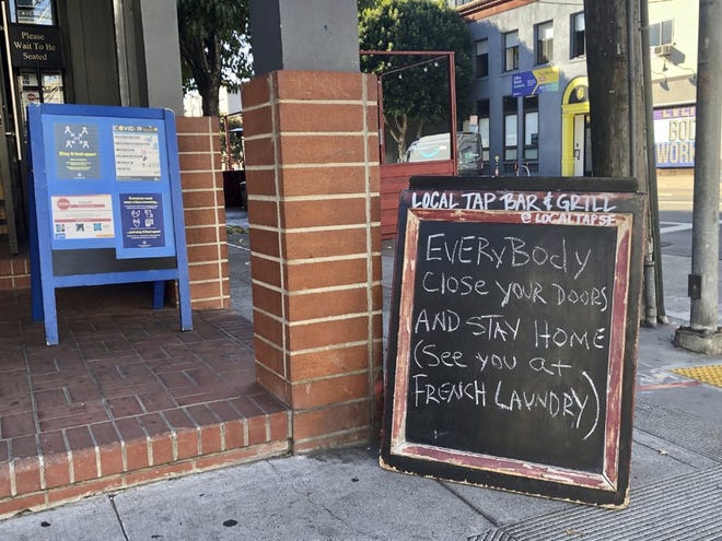 A sign calling out California Gov. Gavin Newsom for not following his own pandemic protocols at the French Laundry restaurant is seen in San Francisco on Dec. 8, 2020.