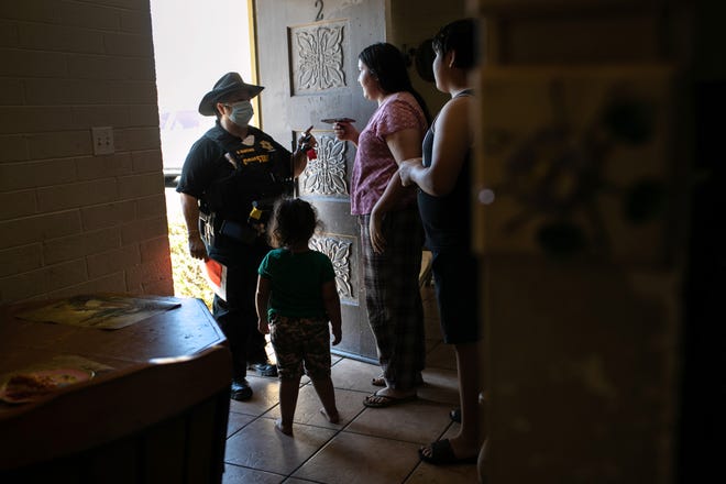Maricopa County constable Darlene Martinez speaks to a renter about an eviction order on Oct. 1, 2020, in Phoenix, Arizona. Federal rental assistance is expected to pass in Congress Monday as part of a $900 billion pandemic relief package.