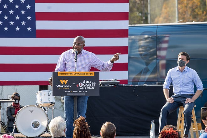 US Senate candidate Rev Raphael Warnock shares the stage with Democratic candidate Jon Ossoff during a Saturday afternoon rally in Garden City.