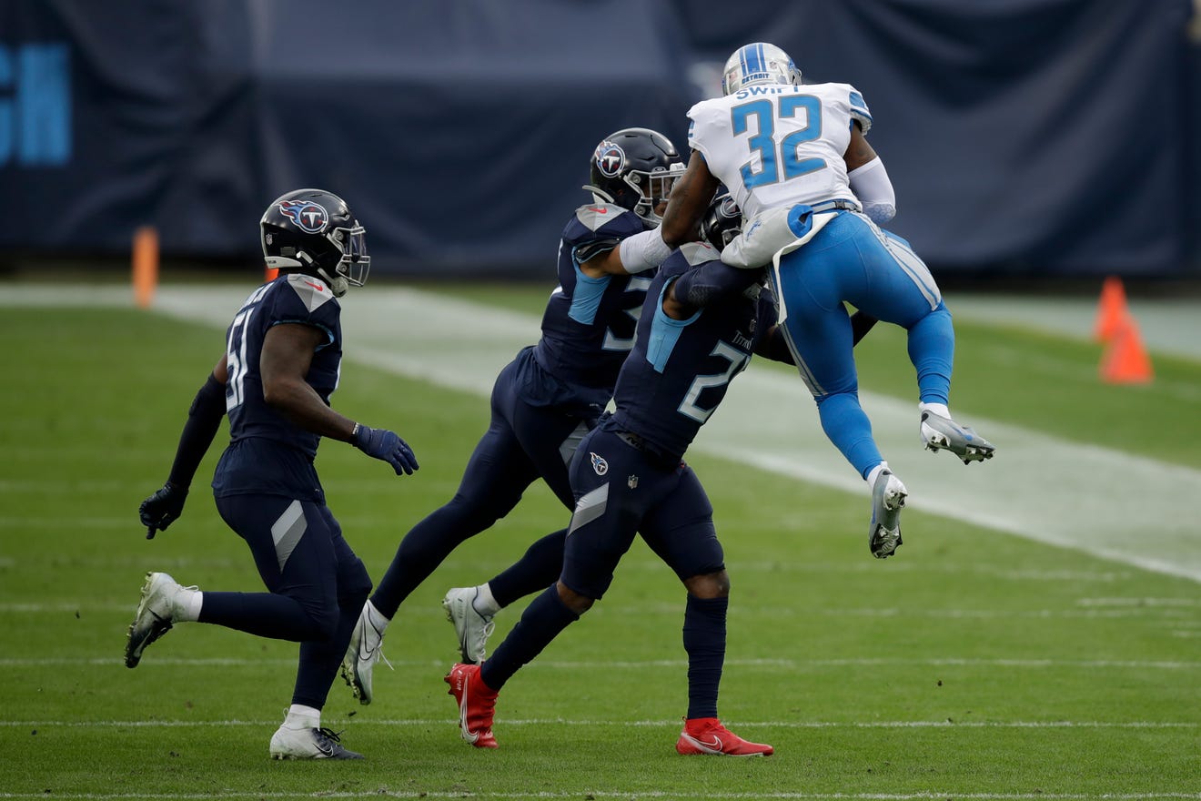 Detroit Lions running back D'Andre Swift is tackled by the Tennessee Titans during the first half.