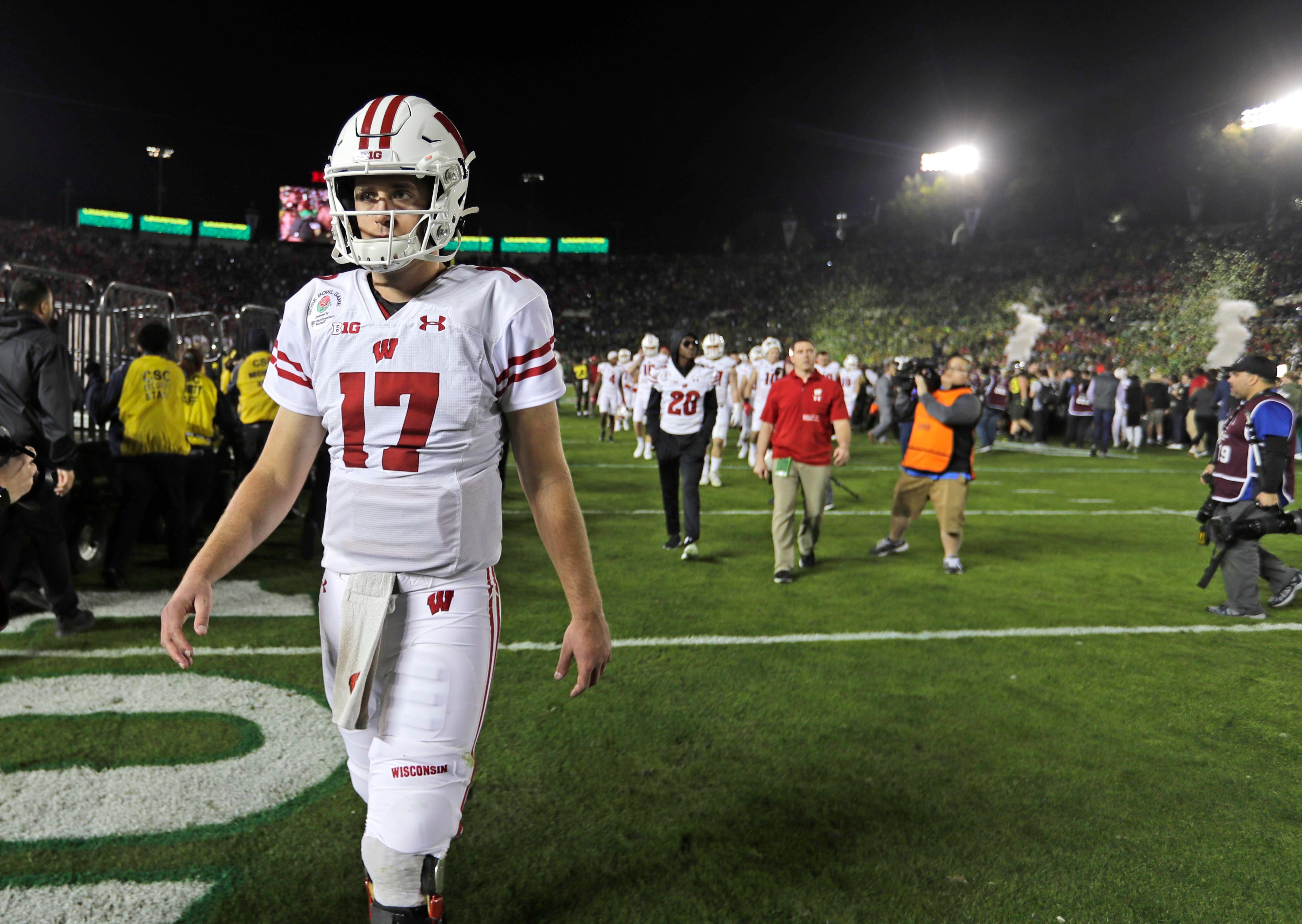 Wisconsin Badgers quarterback Jack Coan walks off the field after Oregon's 28-27 win over the Wisconsin Badgers in the 2020 Rose Bowl game Wednesday, Jan. 1, 2020 in Pasadena, Calif. Wisconsin had 4 turnovers in the game. RICHARD WOOD/USA TODAY NETWORK/MILWAUKEE JOURNAL SENTINEL 