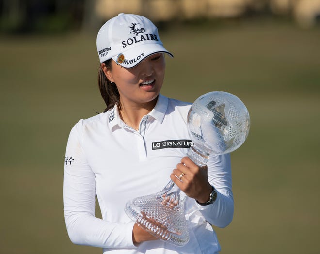 Jin Young Ko with the trophy after winning the CME Group Tour Championship during the final round of the CME Group Tour Championship golf tournament on Sunday, December 20, at Tiburon Golf Club in Naples.