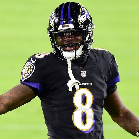 Ravens quarterback Lamar Jackson (8) greets wide r