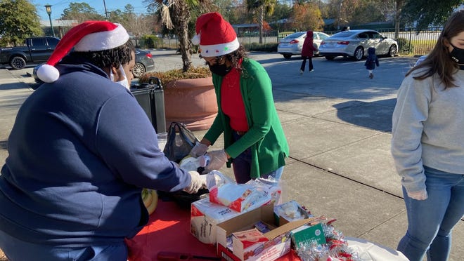 Hardeeville native La'Quisha Devoe, center, and other volunteers served free breakfast Dec. 19 at the Jasper County Farmers Market. Devoe, an Army veteran and survivor of Hodgkin lymphoma, established Survivors by Que in July. The organization was the main sponsor of the drive-thru event.