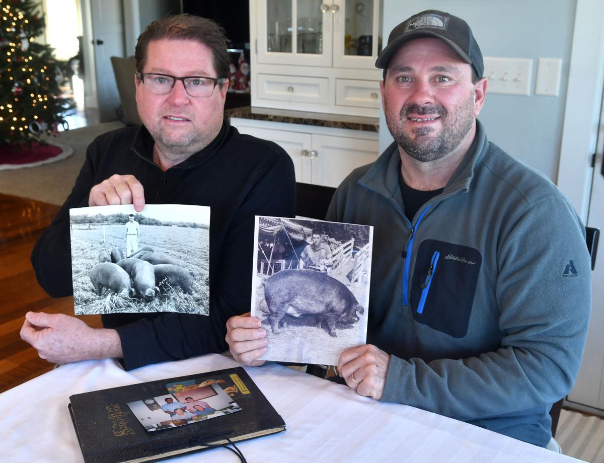 Jeff and Brett Grings of Wilton holds photos of their father Jerry Thomas Grings who died on Nov. 28, 2020 at UnityPoint-Trinity Bettendorf hospital from complications with COVID-19.