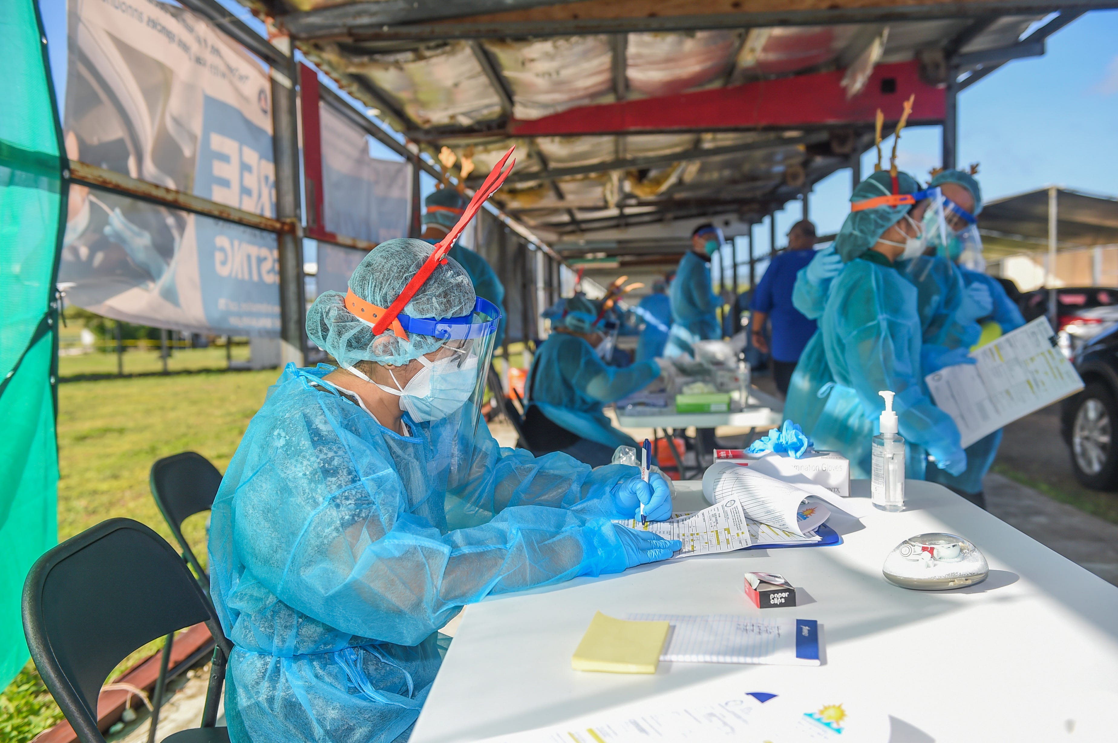 The Department of Public Health and Social Services conducts mass community COVID-19 testing at the Tiyan carnival grounds in this Dec. 21, 2020, file photo.