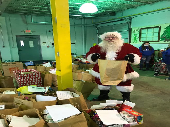 Santa, also known as volunteer Charlie Justice, Saturday helped to deliver Christmas gifts to 390 children who come to the Richland Outreach Center, now located at their new home in the former Toy Time building at 280 N. Diamond St.