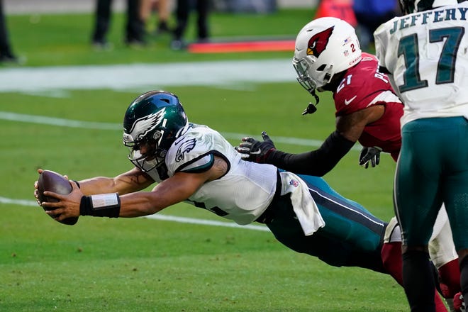 Philadelphia Eagles quarterback Jalen Hurts (2) dives in for a touchdown as Arizona Cardinals cornerback Patrick Peterson (21) defends during the second half of an NFL football game, Sunday, Dec. 20, 2020, in Glendale, Ariz. (AP Photo/Ross D. Franklin)