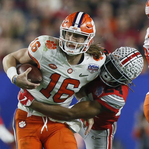 Clemson quarterback Trevor Lawrence is tackled by 