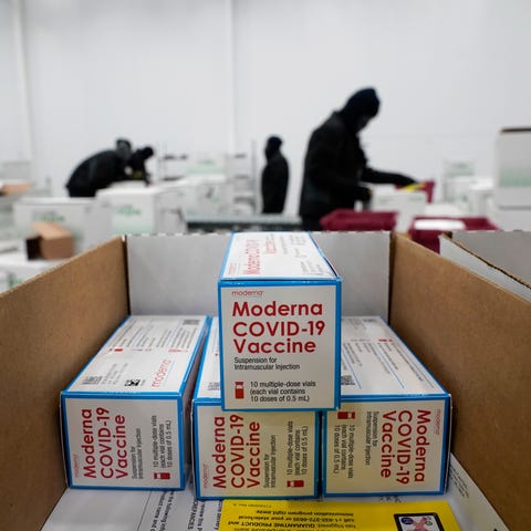 Boxes containing the Moderna COVID-19 vaccine are 