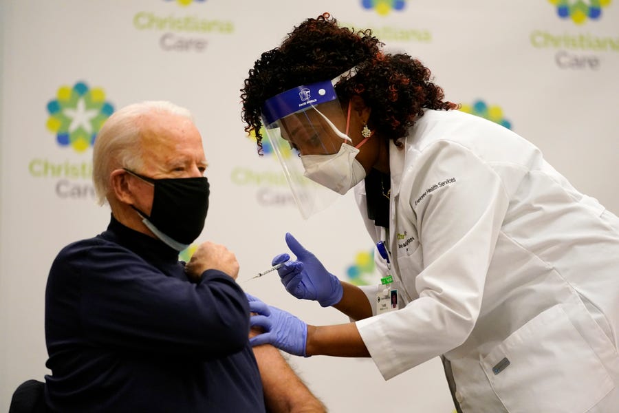President-elect Joe Biden receives his first dose of the coronavirus vaccine at ChristianaCare Christiana Hospital in Newark, Delaware, Monday, Dec. 21, 2020, from nurse practitioner Tabe Mase.