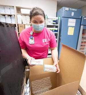 Pharmacy supervisor Laura Chapman unpacks units from Akron Children’s Hospital’s first shipment of the Moderna COVID-19 vaccine on Dec. 22.
