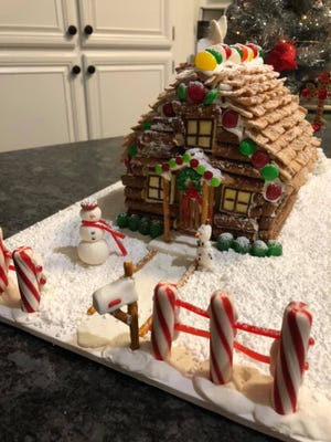 The Rogers Family received first place in the family category of the gingerbread decorating contest with their "Cozy Christmas Cabin."