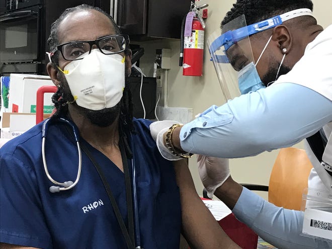 Licensed practical nurse Ronald "Rhon" McGee was one of the first staffers at the Ascension Living St. Catherine Labouré Place nursing home in Jacksonville to receive the COVID-19 vaccine.