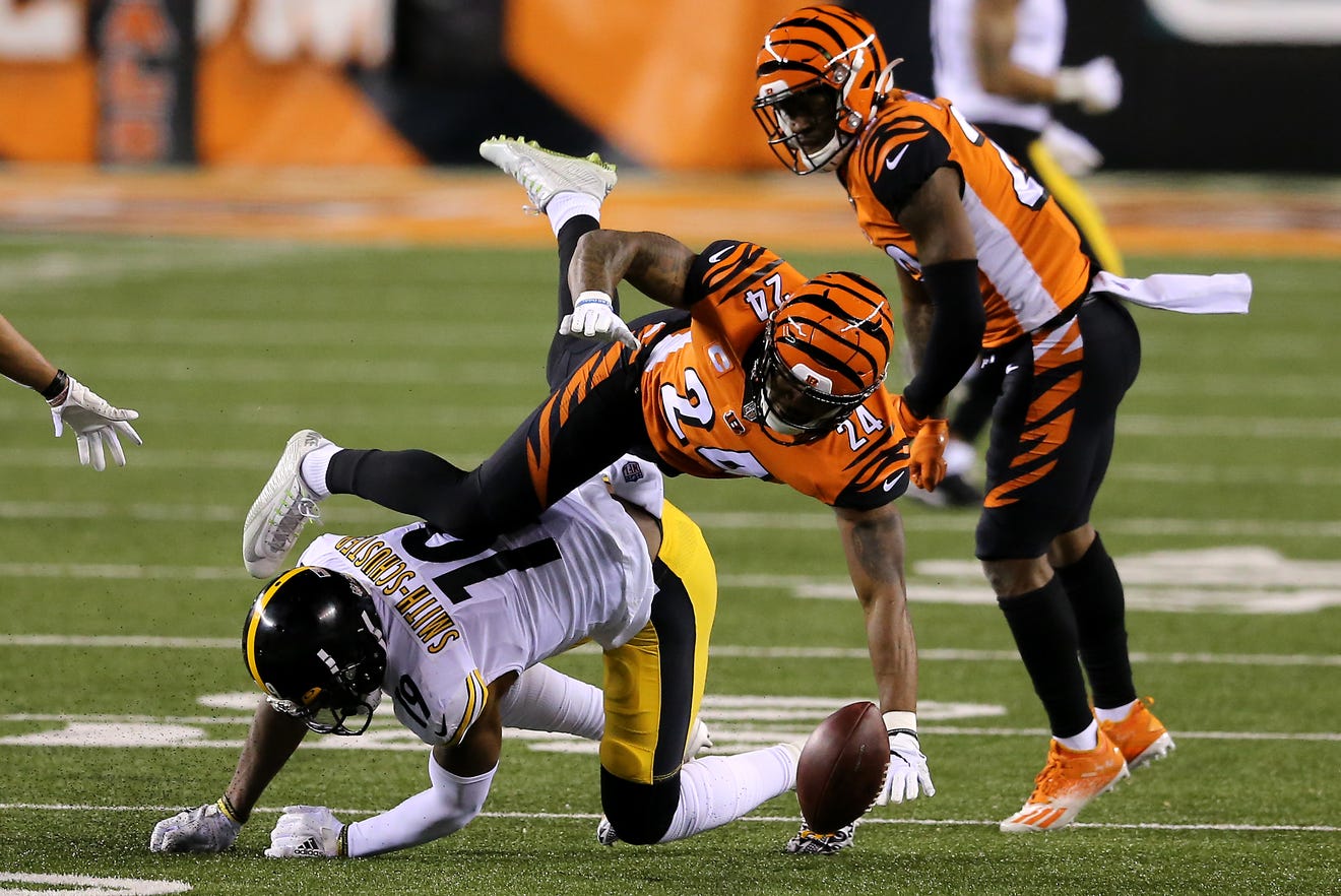 Cincinnati Bengals strong safety Vonn Bell (24) forces a fumble of Pittsburgh Steelers wide receiver JuJu Smith-Schuster (19) in the first quarter during an NFL Week 15 football game, Monday, Dec. 21, 2020, at Paul Brown Stadium in Cincinnati. 