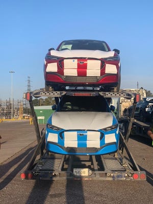 All-electric 2021 Ford Mustang Mach-E SUVs are seen loaded up on car haulers on December 19, 2020 after being assembled at the Ford plant in Cuautitlán, Izcalli, Mexico.