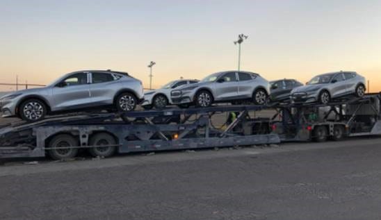 All-electric 2021 Ford Mustang Mach-E SUVs are being hauled to rail cars on December 19, 2020 after being assembled at the Ford plant in Cuautitlán, Izcalli, Mexico.