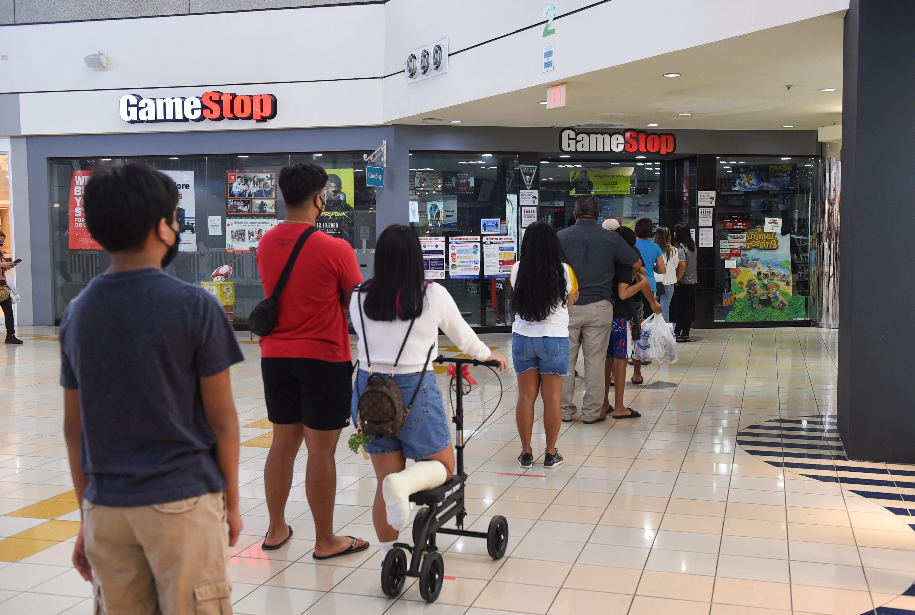 GameStop customers line up outside the Micronesia Mall location, Dec. 22, 2020.