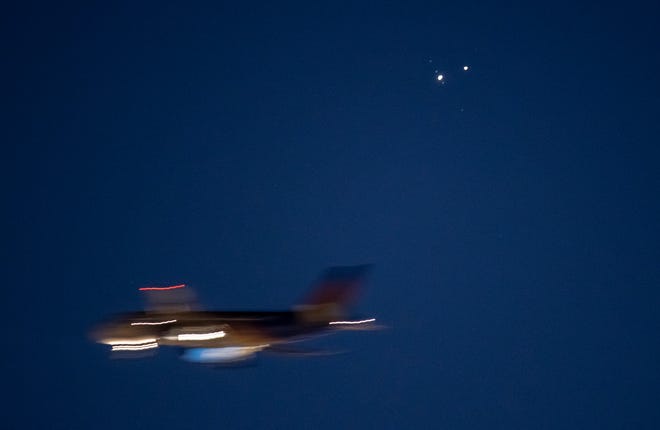 The "Christmas Star" is visible in the Louisville sky as a plane passes by  Monday evening as the bright planets of Jupiter and Saturn come closer together in what is called a "planetary conjunction." According to NASA, it has been nearly 800 years since the two planets passed this close in the night sky. Dec. 21, 2020