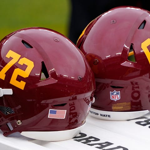 Washington Football Team helmets sit on the sideli
