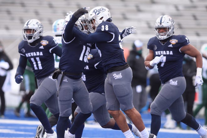 Nevada's Christian Swint (38) celebrates his interception against Tulane with some Wolf Pack teammates.