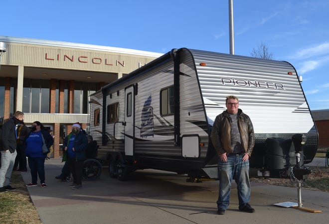 Jayden Wallace, 18,stands in front of his new camper after school Tuesday, Dec. 22, 2020, at Lincoln High School. He was surprised with the camper by the Make-A-Wish Foundation after being diagnosed with cystic fibrosis.