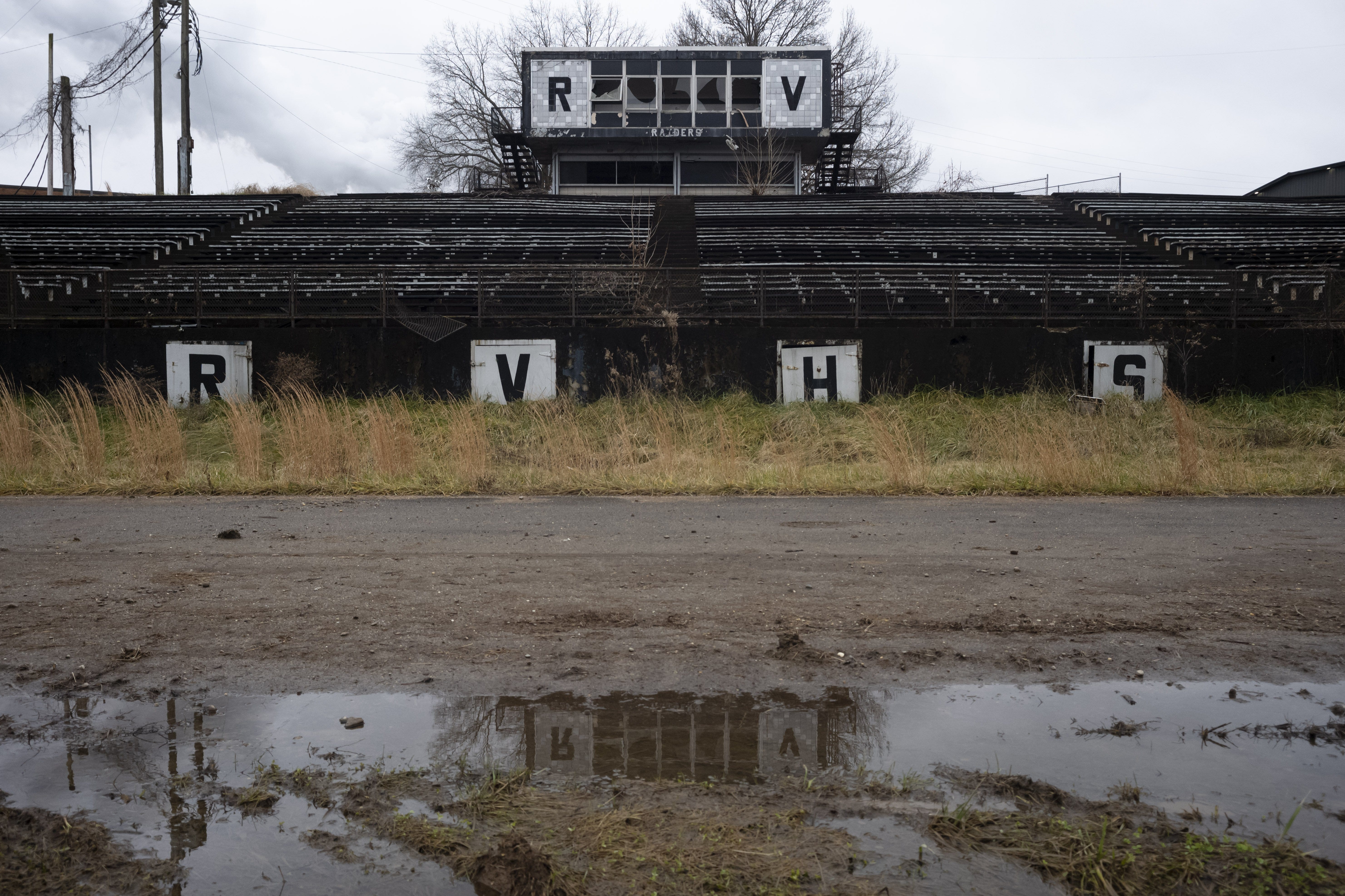 The stadium stands of the former River Valley High School on Monday, Dec. 21, 2020 in Cheshire, Ohio, the site of a coal-burning power plant. Before residents moved away having been paid by American Electric Power, during sporting events, “all the other schools would just complain so much because of the smell of the air that they had to run in,” a former student said.