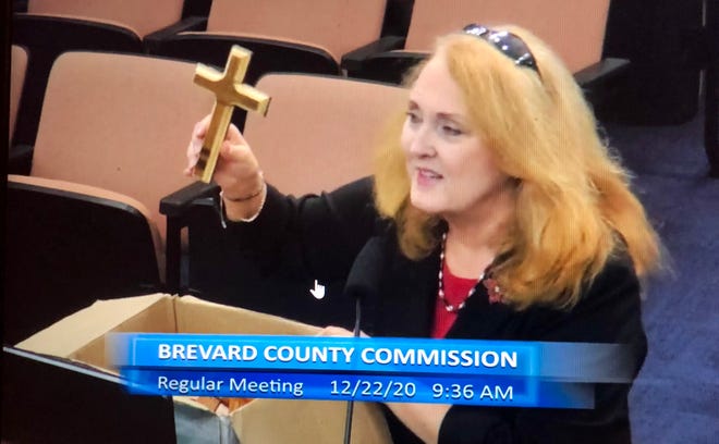 Evie Ostrander, a member of the ministerial staff at the Mission Church in Palm Bay, spoke in favor of the County Commission's proposed invocation policy on Tuesday and brought handmade wooden crosses to the meeting for the commissioners.