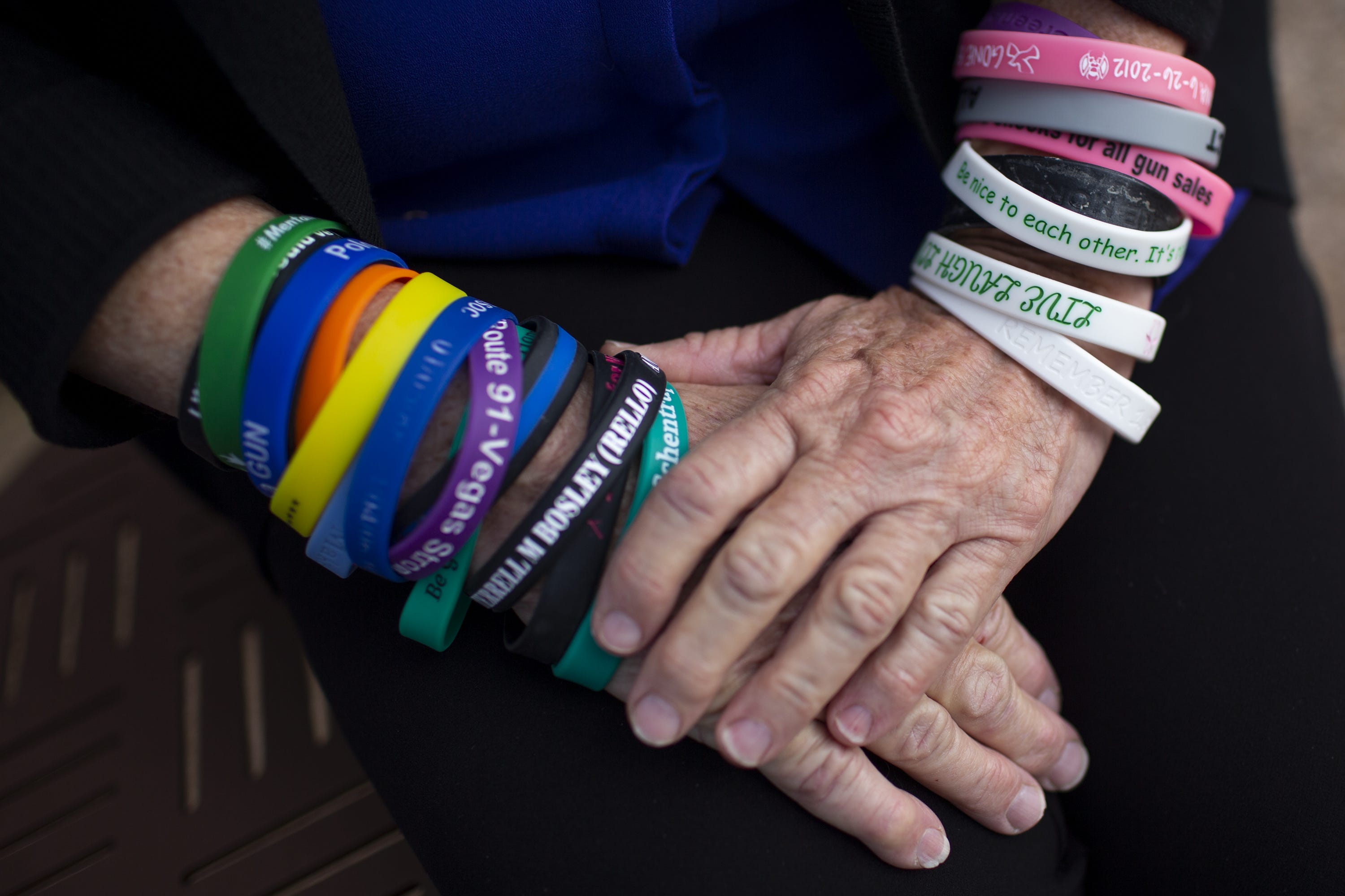 Patricia Maisch wears about 20 silicone bracelets representing people killed by gun violence.