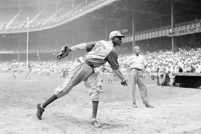 Satchel Paige of the Kansas City Monarchs warms up at New York's Yankee Stadium before a Negro League game in 1942 between the Monarchs and the New York Cuban Stars.