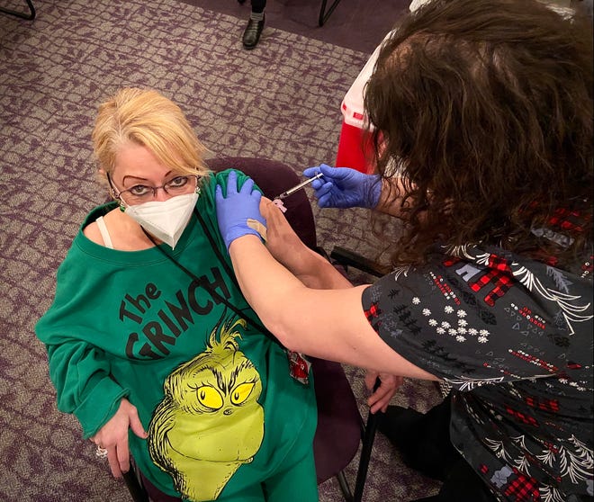 SSTAR employee Debra Crepeau didn't flinch Wednesday as she was given a Moderna COVID-19 vaccine shot.