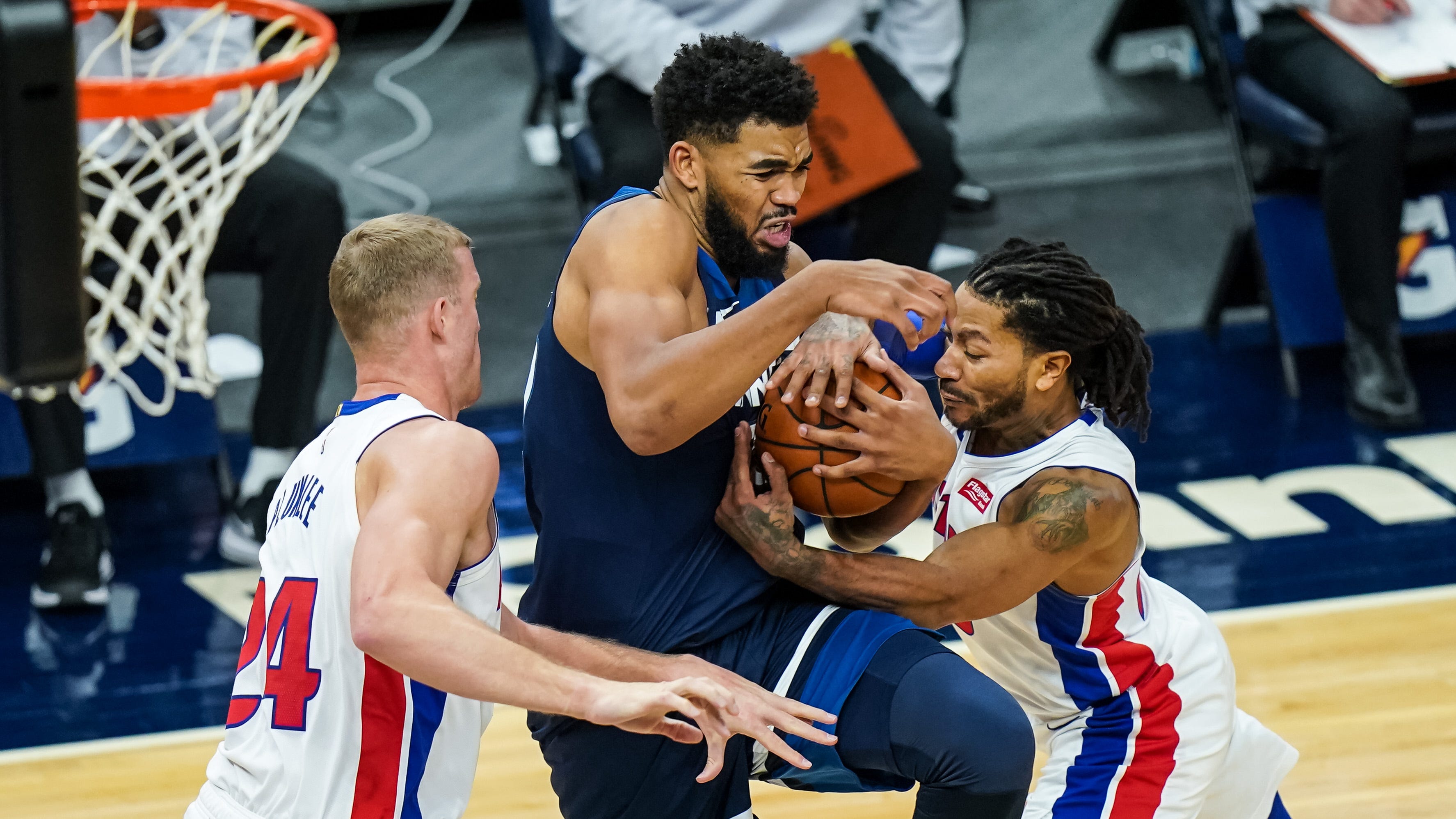 Minnesota Timberwolves center Karl-Anthony Towns drives past Detroit Pistons center Mason Plumlee, left, and guard Derrick Rose during the fourth quarter at Target Center, Dec. 23, 2020 in Minneapolis.