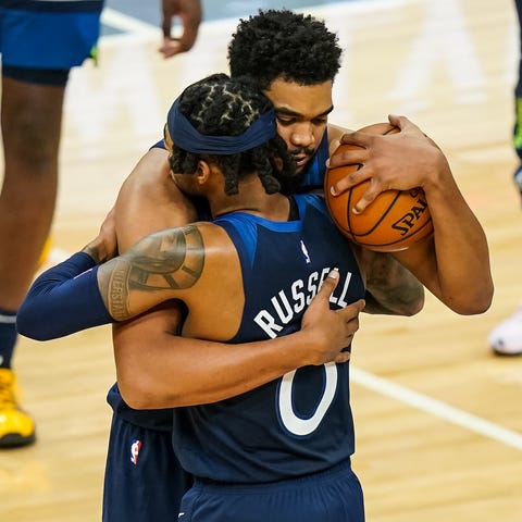 Minnesota center Karl-Anthony Towns hugs guard D'A