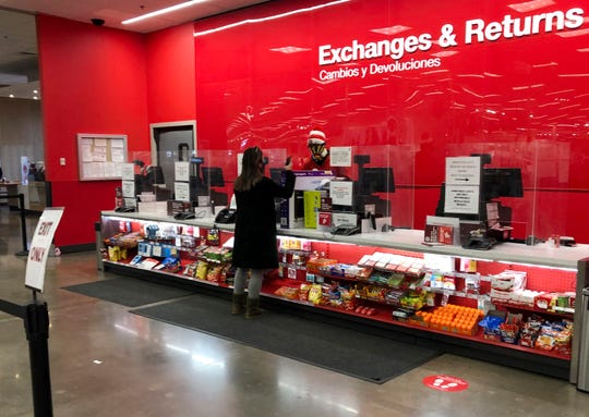A customer is shown at the exchanges and return counter in a Target department store Wednesday in Glendale, Colo.