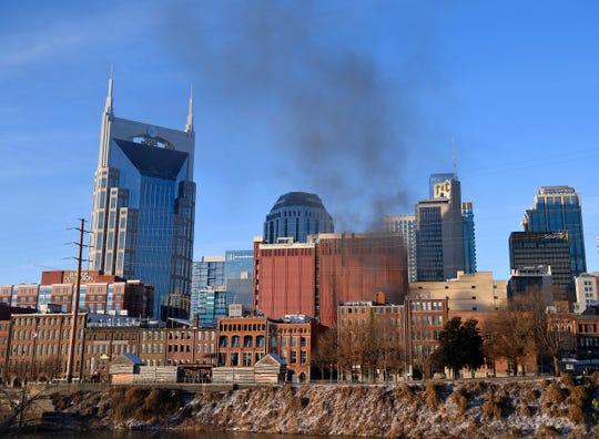 Smoke rises from downtown after an explosion in the area of Second and Commerce Friday, Dec. 25, 2020 in Nashville, Tenn.