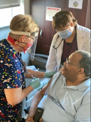 A veteran patient at the Fayetteville Veterans Affairs Coastal Health Care System's community living center in Fayetteville receives the COVID-19 vaccine. Clinicians have contacted nearly all of 281 patients who received expired Pfizer shots, a spokesperson said.