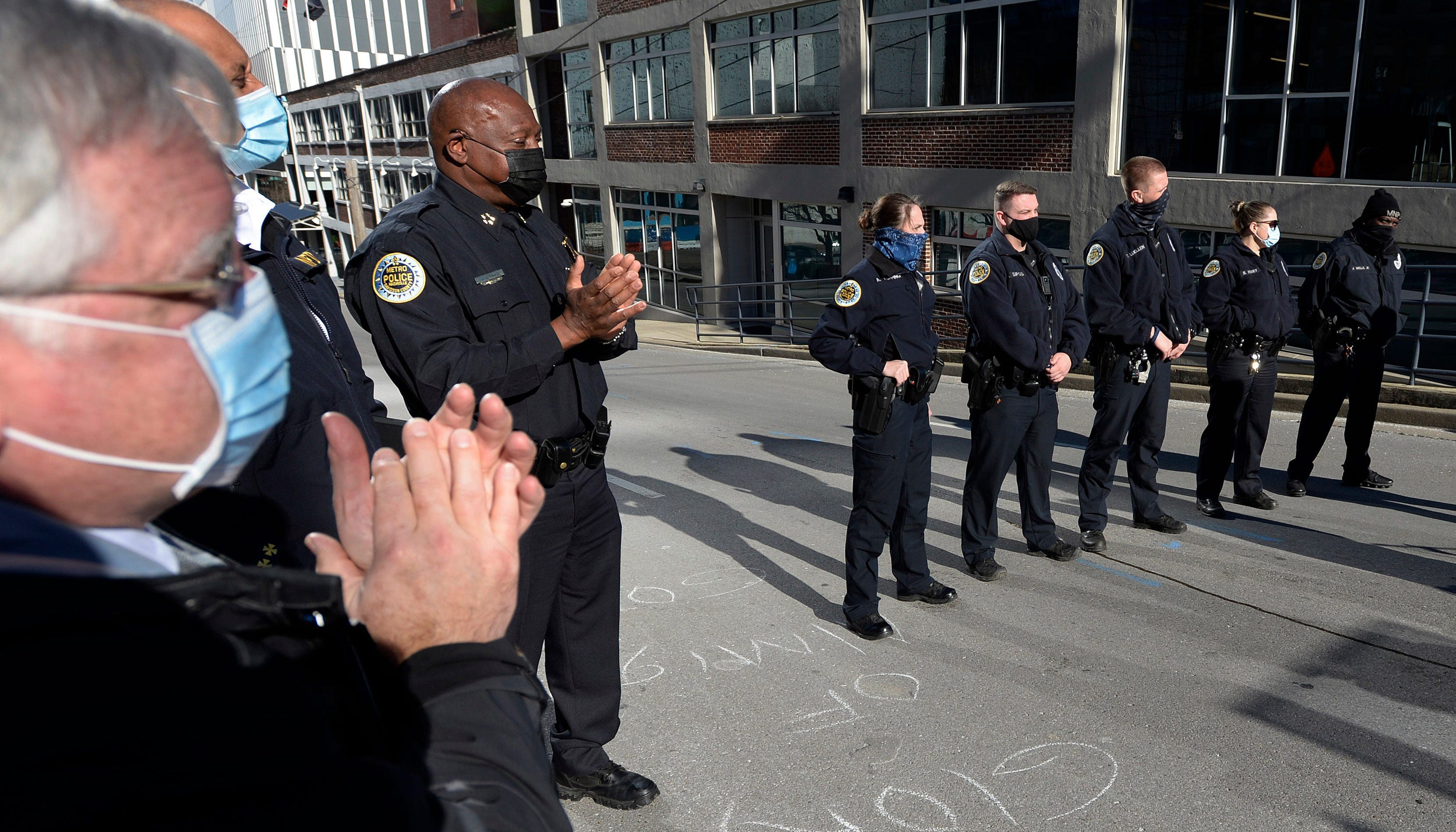 Nashville Mayor John Cooper, left, and Nashville Metro Police Chief John Drake applaud after the officers Amanda Topping, Michael Sipos, James Luellen, Brenna Hosey, and James Wells spoke about their experiences saving lives before the explosion on Christmas Day. The spoke at a press conference on Sunday, December 27, 2020 in Nashville, Tenn.
