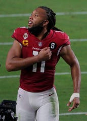 Dec 26, 2020; Glendale, AZ, USA;  Arizona Cardinals wide receiver Larry Fitzgerald (11) leaves the field after the last home game of the season at State Farm Stadium. Mandatory Credit: Cheryl Evans-Arizona Republic