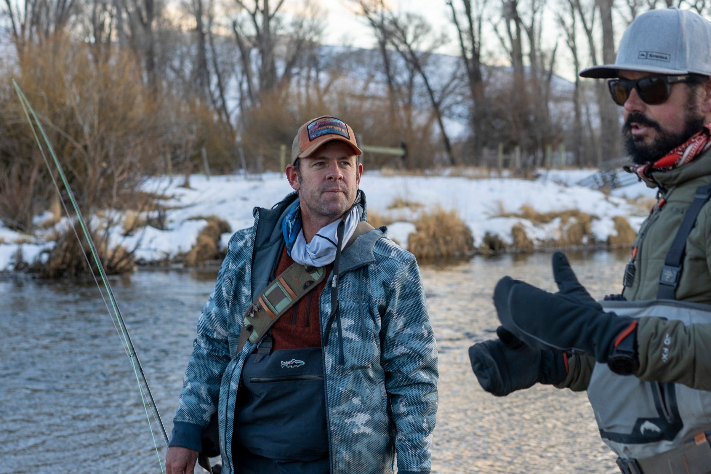 Matt Rice, left, director of the Colorado River Basin Program for the conservation group American Rivers, visits with rancher Paul Bruchez, right, as they fish for trout in the Colorado River near Kremmling, Colorado.