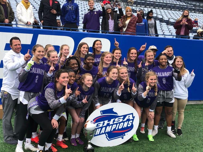 The Calvary Day School girls flag football team poses for a photo after defeating Portal 6-0 in the first-ever GHSA Class 1A-5A state championship game on Monday at Center Parc Stadium in Atlanta.