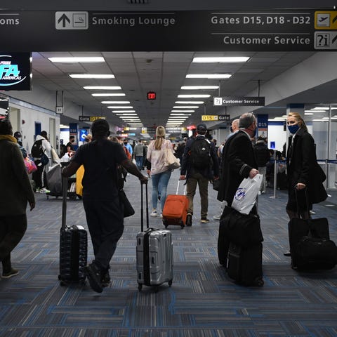 Travelers crowd a terminal at Dulles International