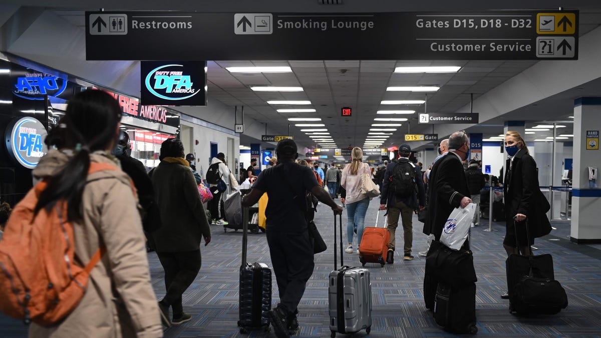 Travelers crowd a terminal at Dulles International Airport outside of Washington, D.C., on Sunday, Dec. 27. The Transportation Security Administration says it screened nearly 1.3 million passengers Sunday, more than any other day since the pandemic began.