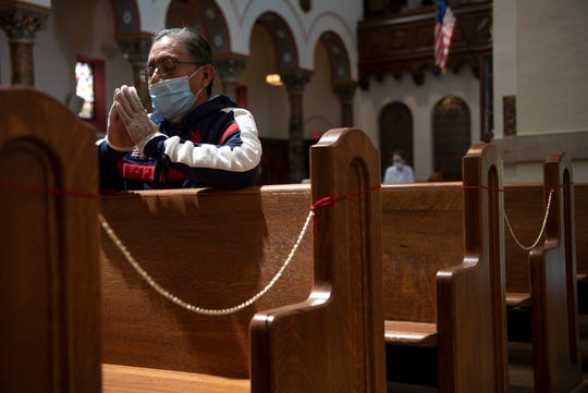 Jose Lozado prays at Holy Trinity Church in Hackensack in May, 2020, on the first the day the church reopened during the coronavirus pandemic. Every other pew is roped off to encourage social distancing and face masks are required. We dare to imagine a day when that might not be necessary.