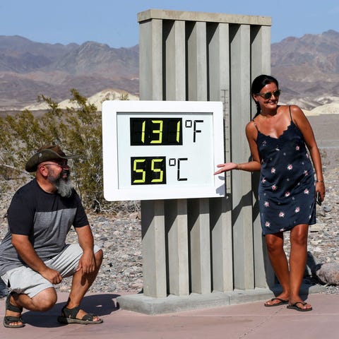 Visitors gather for a photo in front of an unoffic